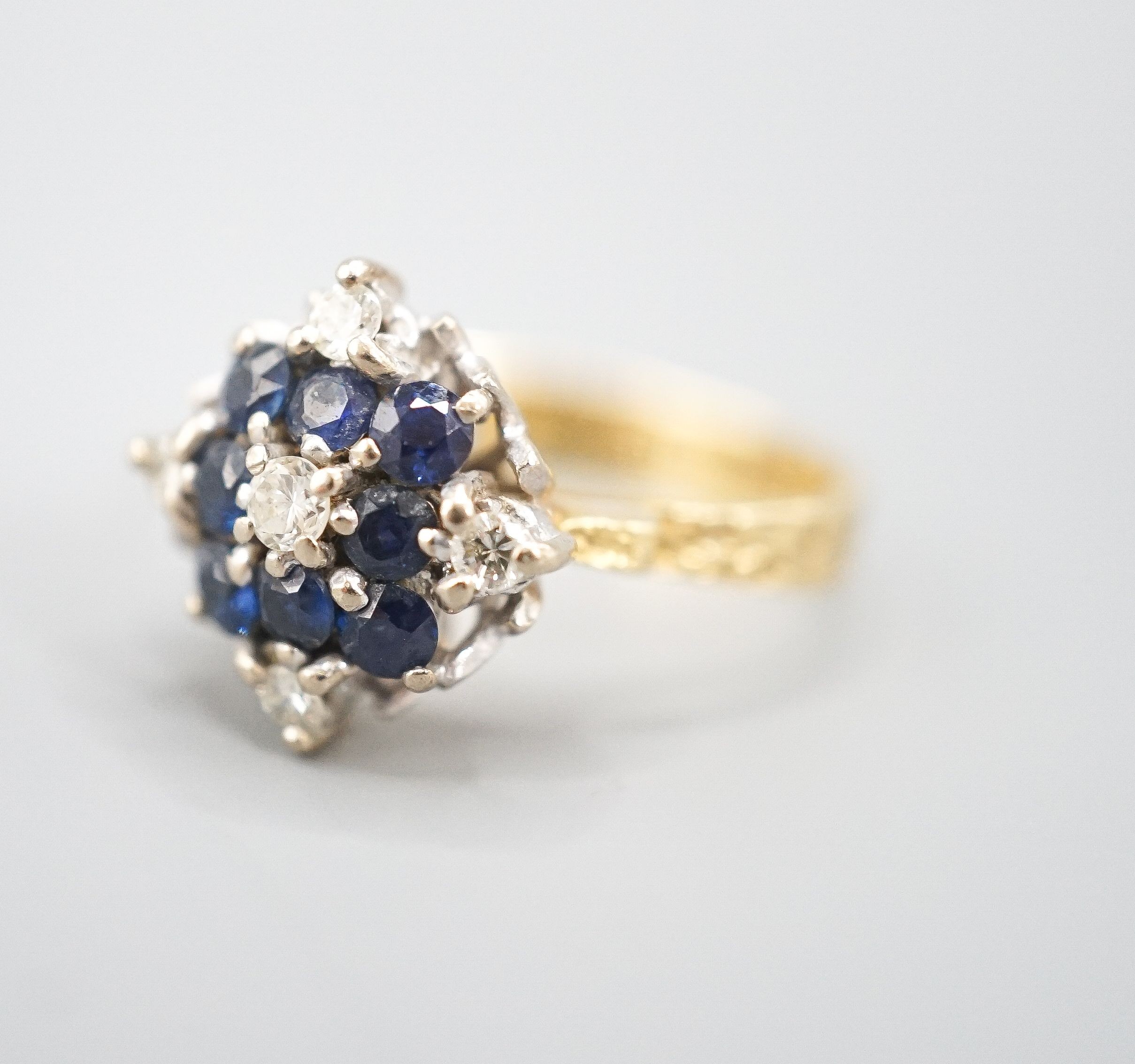 A 1960's 18ct gold, sapphire and diamond cluster ring, size Q, gross weight 5.8 grams.